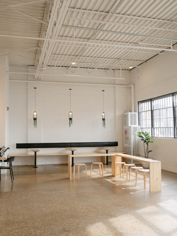 Empty event room with wooden tables and hanging lights