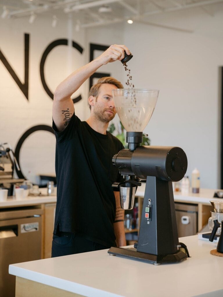 Coalescence Coffee barista dialing in specialty coffee grind for consistent espresso drinks